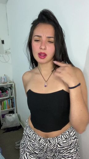 Woman in black tank top and zebra print pants