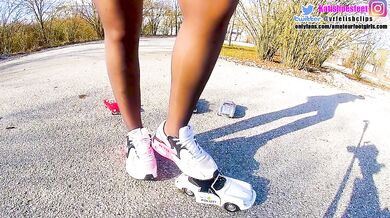 Kati steps on sneakers crushing old cars till they're scrap metal