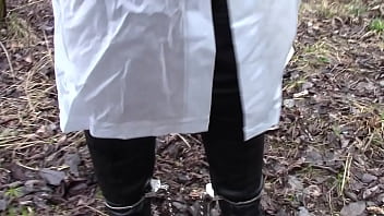 In raincoat with handcuffs and legcuffs