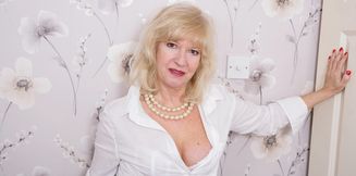 Sexy British blonde grandma Emily Jane in white lingerie masturbates her shaved pussy