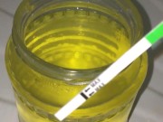 Girl in black stockings filled a large jar of urine. 4th ovulation test / Pissing