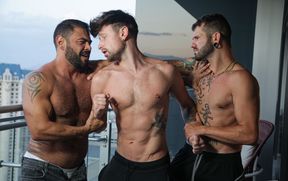 Fine male gets shared by two hunks in superb gay threesome
