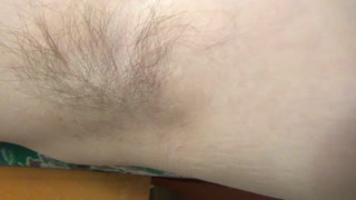 Blonde hairy armpit hair showing in armchair