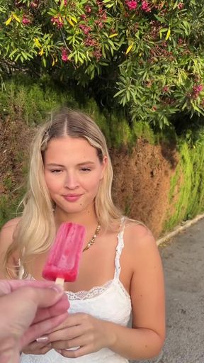 Blonde woman holding popsicle