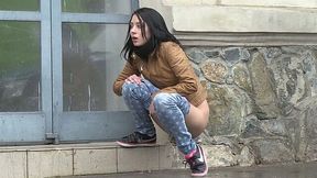 Seductive dark haired girl makes piss outdoors during rainy day