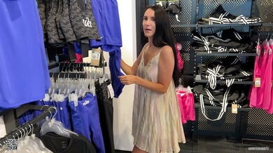 Long-haired beauty teases in sheer dress as vibrator play builds to changing room tension