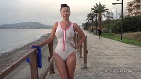 MILF shows off her wet swimsuit at the beach