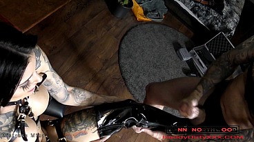 Latex Mistress has her Pvc Boots worshipped by Tattoed Hunk till he cums