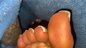 Caressing my beautiful feet under the covers to excite you.