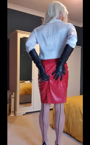Dressed up feeling very sexy in her white satin blouse, shiny red skirt, opera leather gloves, nude seamed stockings and heeels.