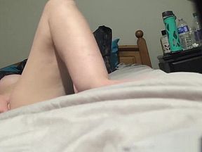 Orgasming loudly during the masturbation on a bed