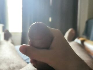 Masturbating with some sun rays throughout the window