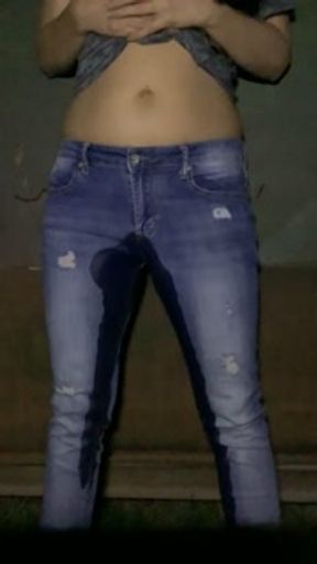 Girl pees her pants standing up in jeans