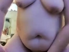 A mature plump girl is bouncing on a rubber dick