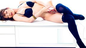 ”Decadent Yuria in black lingerie & black thigh high stockings toys her cunt.”