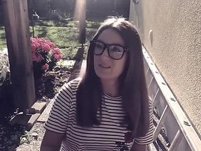 Girl blow up balloons in her backyard