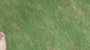 Woman with sensual feet walks barefoot on the grass