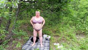 Neighbor strips in a park and strokes her large clit