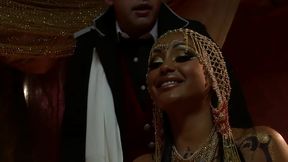 belly dancer in gold coins drilled by the officer on red silk sheets