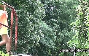 Peeing babes empty their bladders in a park being part of voyeur pee video