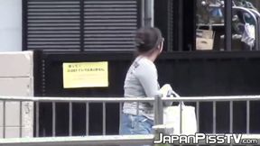 ”Japanese with big tits peeing on parking & later in”