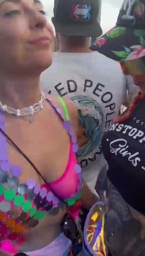 Lesbian tattooed women show off their tits at a public festival