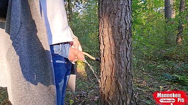 I pee outdoors in the forest under a tree