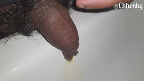 Close-up pissing in the sink