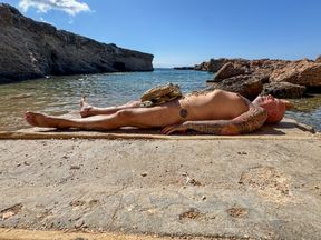 Shemale Mistress plays outdoor with her slave paul on the rocks off Ibiza