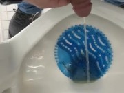 Pissing at a urinal.