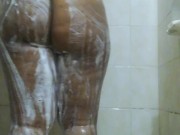 Horny ebony shemale takes a shower