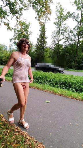 Naked under a mesh shirt on the street