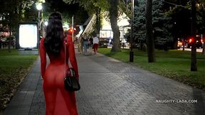 Seductive MOM in red transparent dress teases outdoor onlookers