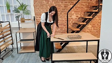 SENSUAL LATINA CARPENTER CUTTING WOOD IN A DIRNDL