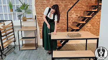 SENSUAL LATINA CARPENTER CUTTING WOOD IN A DIRNDL