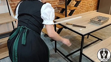 SENSUAL LATINA CARPENTER CUTTING WOOD IN A DIRNDL