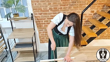 SENSUAL LATINA CARPENTER CUTTING WOOD IN A DIRNDL