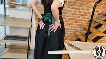 SENSUAL LATINA CARPENTER CUTTING WOOD IN A DIRNDL
