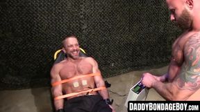 Muscular hunk's rough BDSM torment with restraints