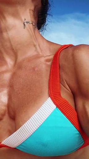Push ups and chest flex on the beach   Clip 1