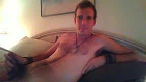 Skinny Man with Hairy Chest Lies on Bed Chatting.