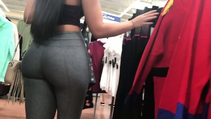 Brunette with tight round ass in clothing store