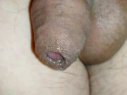 Tiny limp uncircumcised cock playing with precum, lots of foreskin, closeup