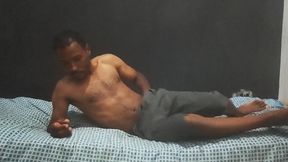 Brunette man in his bedroom masturbating