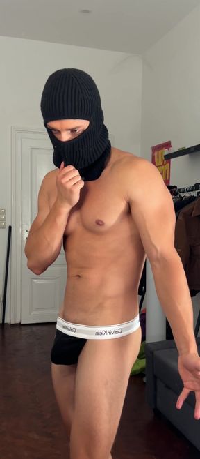 Young hunk flexing his muscles in a tight thong
