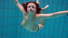 Busty redhead seductress from Russia exposes her pussy