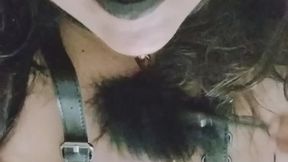 Bdsm outfit playing with a tickle feather