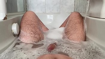 24 year old in the bathtub playing with her feet and cock