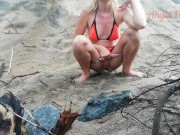 Public peeing teen girl on the beach