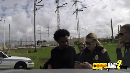 Criminal is getting his black huge cock sucked by two slutty female cops.